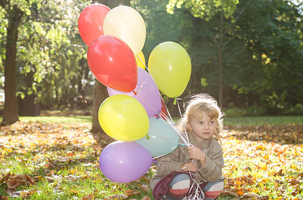 istock girl with balloons 484526330