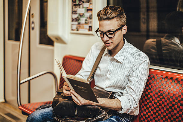 istock Young hipster reading a book on the underground 484526378