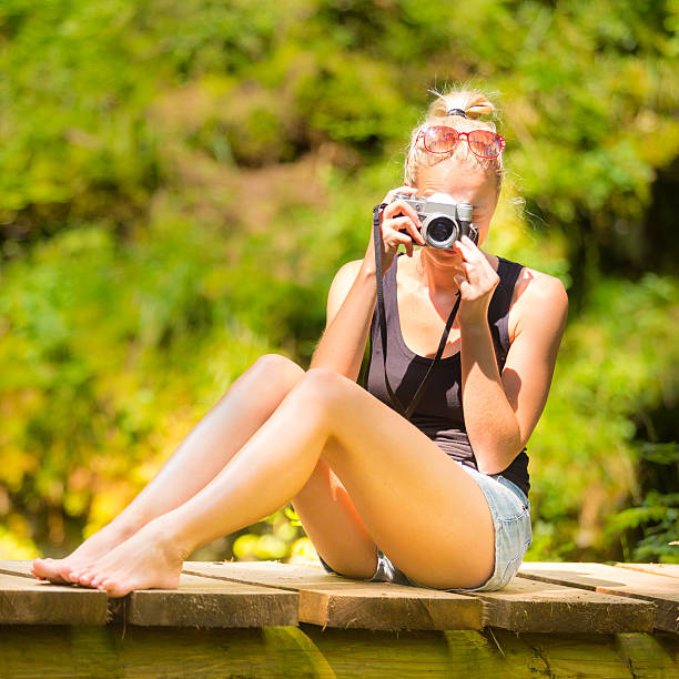 istock Woman in nature with retro camera. 484530886