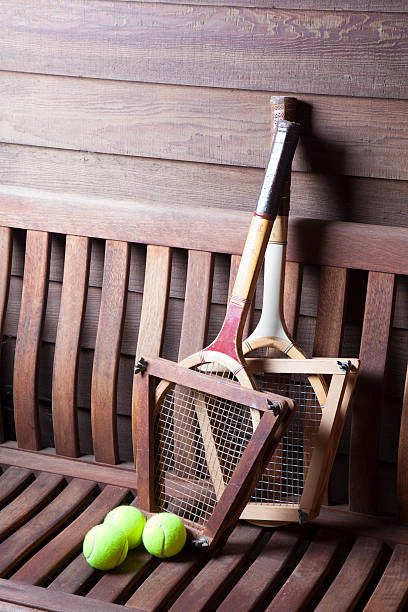 Vintage Tennis Racquets Vintage Tennis Racquets with balls on bench wimbledon seats stock pictures, royalty-free photos & images
