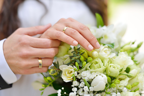 Couple hands on wedding, symbolise forever togetherness and marriage.