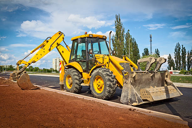 Yellow earth mover in a new road construction