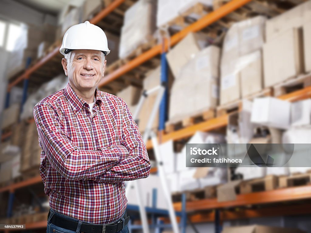 Warehouse Businessman Senior businessman is working in warehouse. Senior Adult Stock Photo