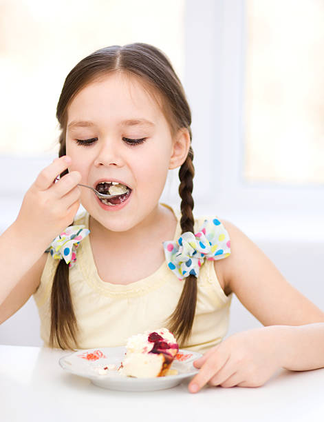 istock Little girl is eating ice-cream 484538689