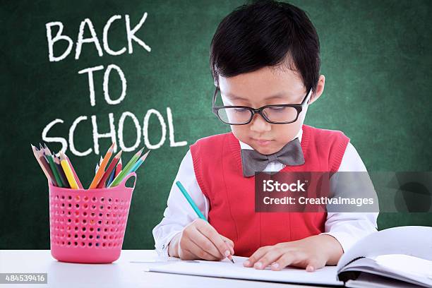 Child Back To School And Drawing In The Class Stock Photo - Download Image Now - Child, Science, 2015