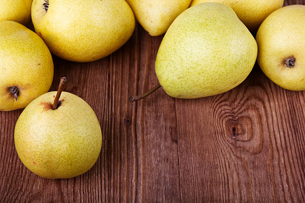 istock pears on old wooden background 484540861