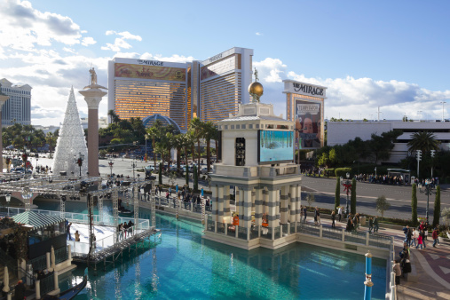 Las Vegas, Nevada, United States - December 27, 2012: The replica canals of Venice at The Venetian Casino in Las Vegas Nevada during the Christmas holidays. A white Christmas tree can be seen on the left and the Mirage Casino across the street in the background.