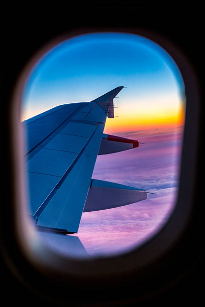 istock View through aircraft window onto the wing on comercial airplane 484541417