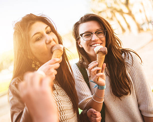 istock group of friends eating icecream on summer 484541563