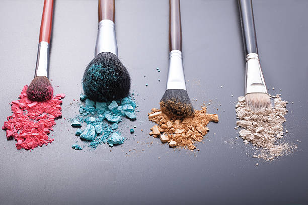 istock Makeup brushes on background with colorful powder 484545462