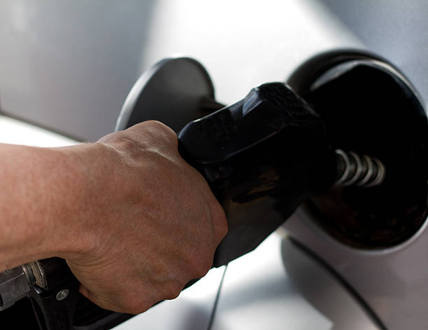 istock Hand Pumping Gasoline into Tank (Close-Up) 484552366