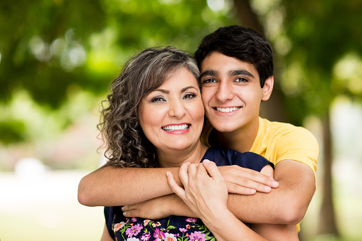 Loving portrait of mother and son smiling in a park