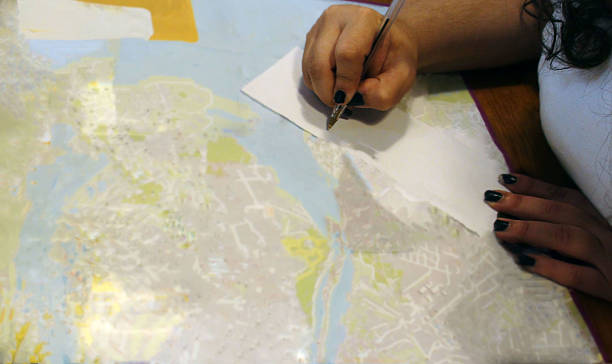 istock Woman Handwriting Tourist Attractions On Paper Map 484553912