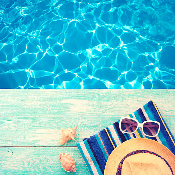 istock Summer vacation. Pink sandals by swimming pool 484556330