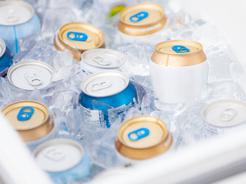 A cooler full of ice cold drinks on a warm Summer afternoon. Labels have been partially removed to avoid trademarks. Add your own label or graphic design.