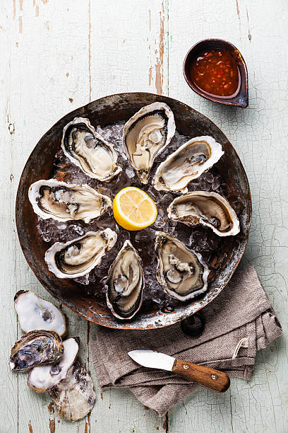 istock Opened Oysters with spicy sauce and oyster knife 484557556
