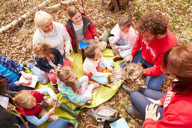 istock Adults And Children Examining Bird's Nest At Activity Centre 484557922
