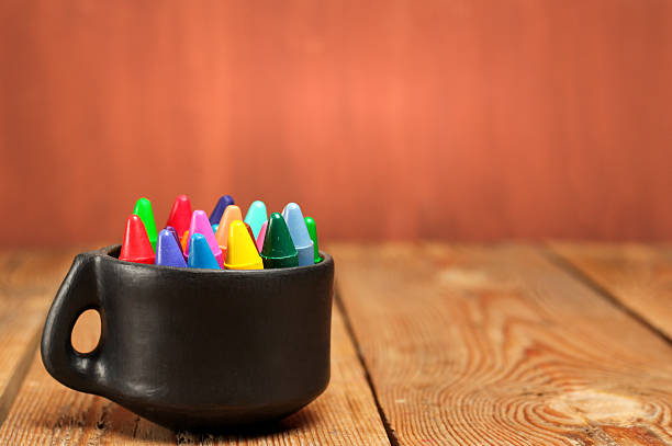 istock Crayons in a mug on a wooden table 484558022