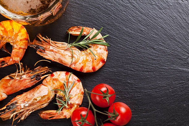 istock Beer mug and grilled shrimps on stone plate 484558286