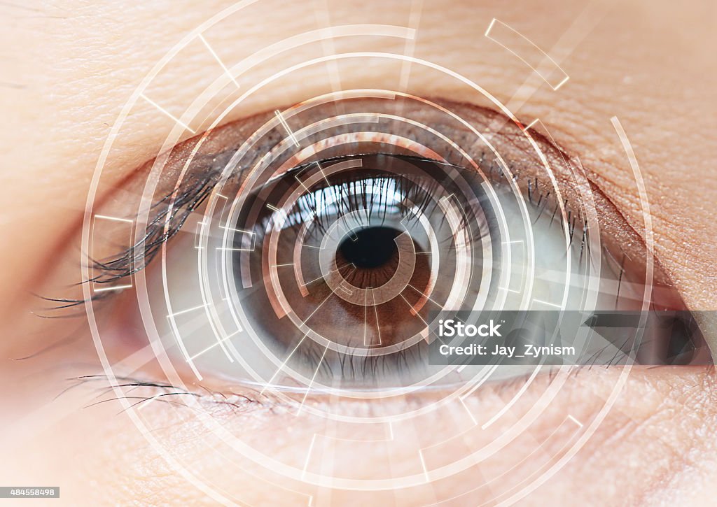 Close-up of woman's brown eye. High Technologies in the future Eye Stock Photo
