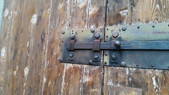 Padlock on an old wooden door.