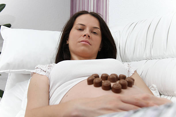 istock Pregnant woman eating chocolate 484559220