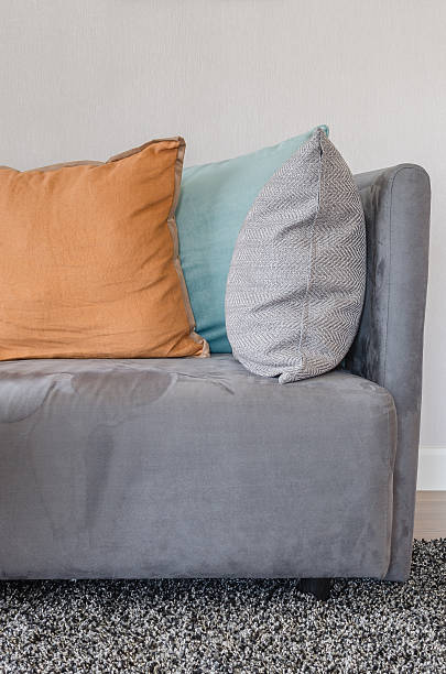 istock orange color pillow on grey sofa in living room 484559266