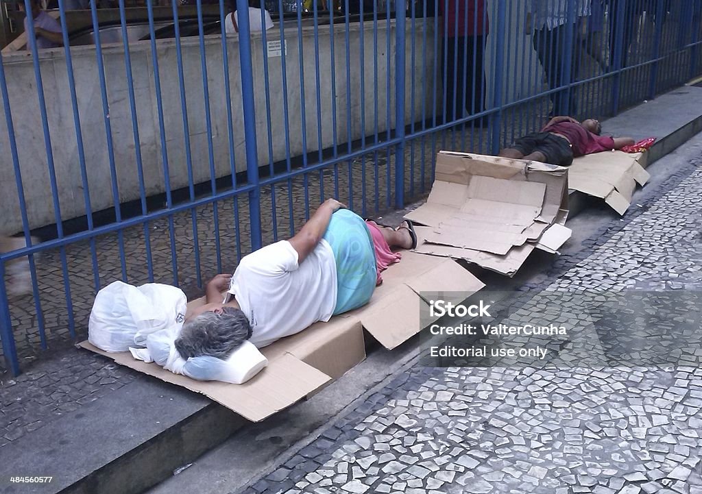 Residents of poor street sleeping on the floor Rio de Janeiro, Brazil - April 12, 2014: Two residents of extremely poor sleep street next to the entrance of the metro station in the city center of Rio de Janeiro, in Brazil, which will host the 2014 World Cup, organized by FIFA to. Homeless Person Stock Photo