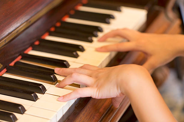 istock Women Hand playing antique piano classic 484562254