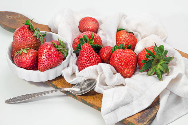 Strawberries and  board cutting on striped napkin stock photo
