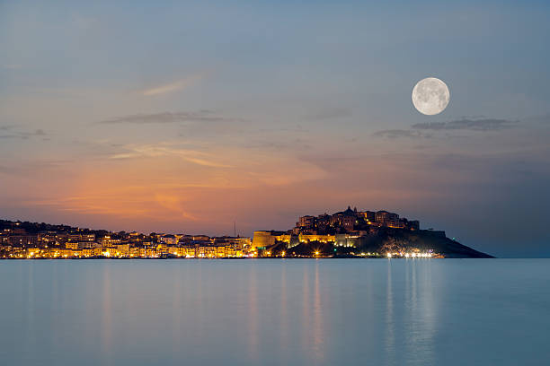 Full moon over Calvi citadel in Balagne region of Corsica stock photo