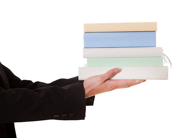 istock Woman holding stack of books 484564060