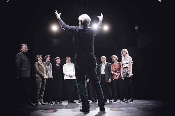 Conductor and Choir on stage Conductor and Choir on stage choir photos stock pictures, royalty-free photos & images