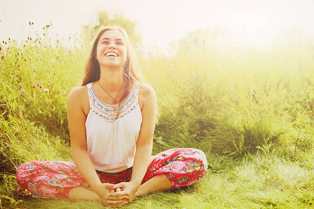 Woman doing yoga in grass.