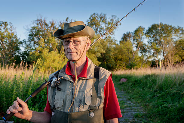 istock Fisherman Returning From Fishing Trip Surrounded By Reeds. 484565744