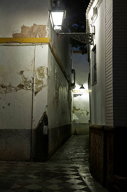 Lanterns light an alley in Seville. stock photo