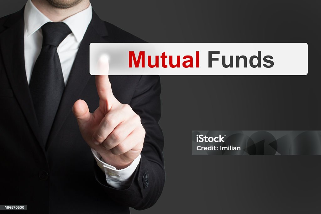 businessman pushing touchscreen button mutual funds businessman in office pushing touchscreen button mutual funds Mutual Fund Stock Photo