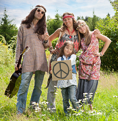 Portrait of hippie family standing in the field with \