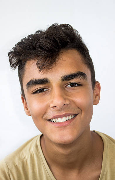 istock Portrait of smiling young man against white background 484571446