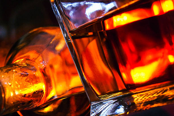 istock Whisky glass and bottle with open fire background 484571898