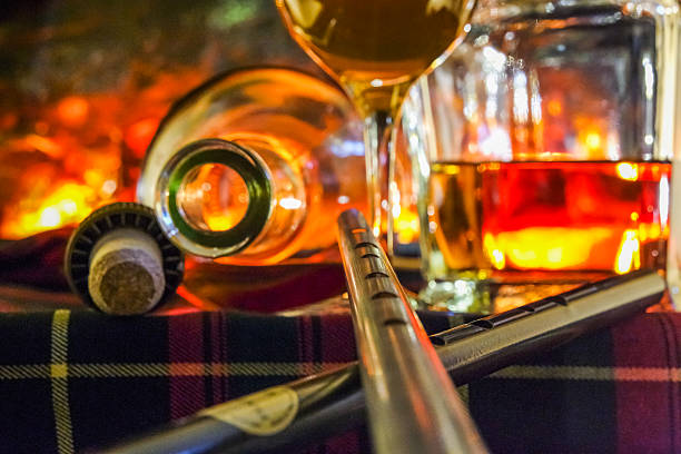 istock Whisky on tartan with open fire background and blurred whistle 484571928