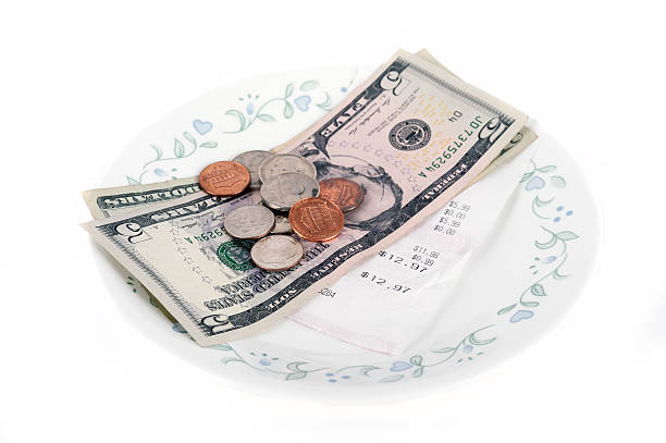 istock Restaurant bill with dollar bills on a plate and receipt 484574908