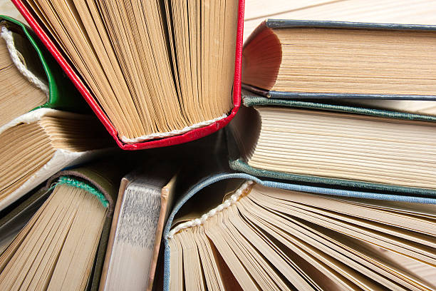 istock Top view of old used colorful hardback books. 484575210