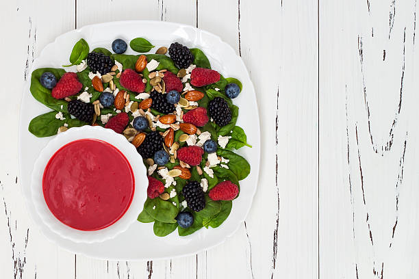 istock Mixed berry salad with almonds, feta cheese and raspberry vinaigrette 484575780