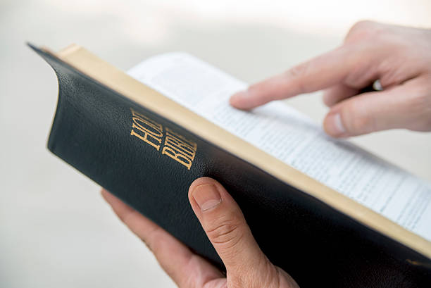 istock Christian Guy Holding an Open Bible, Man Praying 484576082