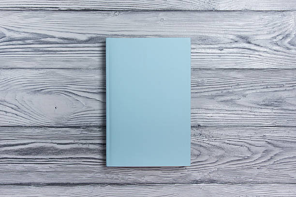 istock Blank book cover on textured wood background. Copy space 484576140