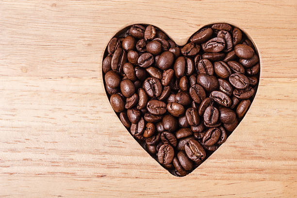 istock Heart shaped coffee beans on wooden board 484576658