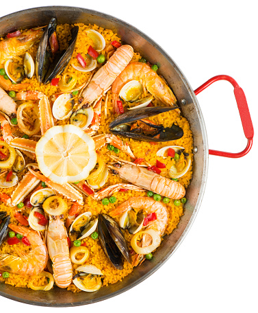 Close-up of delicious mixed Spanish paella; made with rice, mussels,seafood,calamari,prawn,chicken ,herbs , saffron and vegetables.