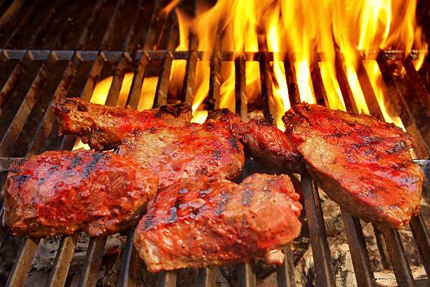 istock Beef Steak on the BBQ Grill with flames. 484577887