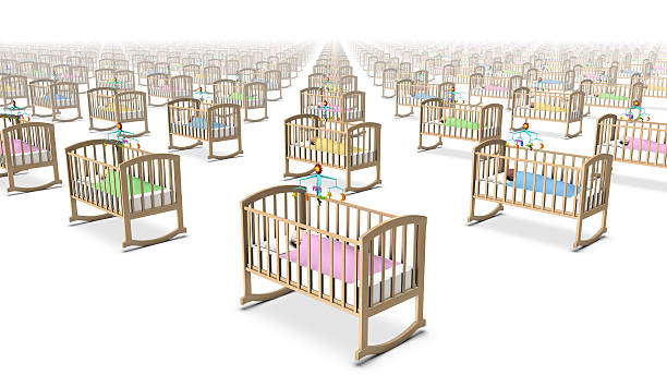 Diagonal high angle view of babies in cribs stock photo